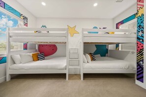A bunk bed room with two beds, a ladder, and colorful wall decorations. - The Reserve at Reunion-TT491 (Kissimmee)