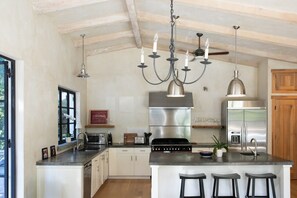 A modern kitchen with a central island, stainless steel appliances, and pendant lighting. - Kenwood Villa - 3BD, Pool, Spa, Sport Court (Kenwood)
