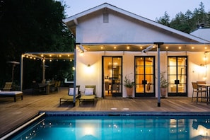 A house with a pool, outdoor seating, and string lights. - Kenwood Villa - 3BD, Pool, Spa, Sport Court (Kenwood)