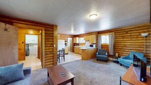 A log cabin interior with a kitchen, dining area, and living room. - Gunni Getaway - Pet Friendly (Gunnison)