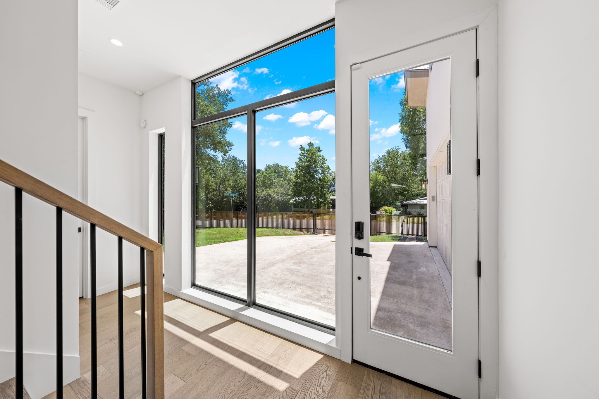 A modern interior with a large sliding glass door leading to a covered outdoor area.
