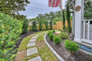 A landscaped garden with a stone pathway leading to a building with a plaque. - Parkside 1922 - Steps to Boone Park & Avondale Shops (Jacksonville)