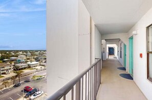 A corridor with a view of a street and buildings. - Island Winds East 809 | Walk to the HangOut! | Gulf Front | Beachside Pool | My Beach Getaways (Gulf Shores)