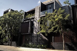 A modern building with a concrete facade, large windows, and a balcony. - The Four Luxury Villas, 8 Pools, 15 BRs, 38 Pax (Tulum)