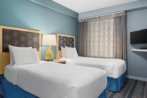 A hotel room with two beds, a TV, a lamp, and a window with curtains. - Peak July Escape! Spacious 2BR Suite in the Heart of Victoria (Victoria)