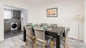 A modern kitchen with a dining area. - 3 Bedroom House - Pool Table, Opp Train Station (Manchester)