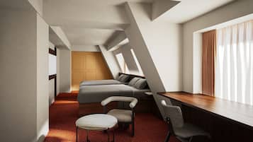 A modern interior with a loft-style ceiling, a sofa, a dining table, and a chair.