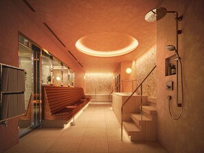A modern bathroom with a wooden bench, a shower, and a staircase.
