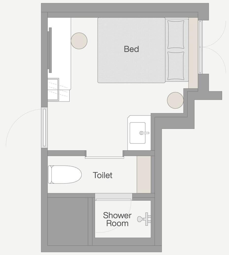 A floor plan of a hotel room with a bed, a toilet, and a shower room.