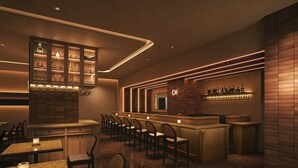 A bar area with seating and a counter, featuring a modern design with ambient lighting. - BASE LAYER HOTEL KOBE SANNOMIYA (Kobe)