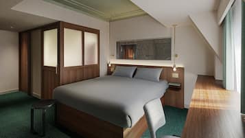 A modern hotel room with a large bed, a desk, a chair, a wardrobe, and a mirror on the wall.