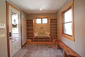 A hallway with a bench, shelves, and a door with a security system. - Haven in the Woods- Luxury Rental in the Heart of Bryson City, NC (Bryson City)