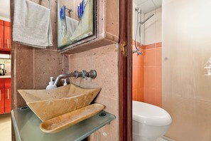 A bathroom with a beige sink, a toilet, and a shower area. - Equipped apartment with parking 2 BR (Ciudad de México)