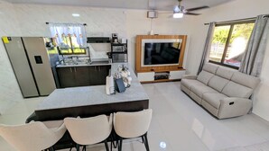 A modern kitchen with a built-in oven, a coffee maker, and a sink.