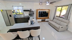 A modern kitchen with a built-in oven, a coffee maker, and a sink.