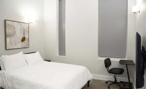 A hotel room with a bed, a chair, a desk, and a large window. - Very large! Penn Station Downtown home w/parking (Baltimore)