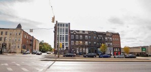 A multi-story building with a mix of architectural styles, including a modern glass facade and traditional brickwork. - Very large! Penn Station Downtown home w/parking (Baltimore)