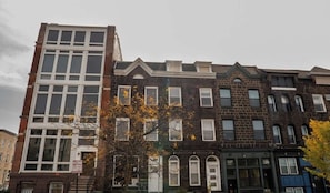 A row of multi-story buildings with varying architectural styles, including brick facades and large windows. - Very large! Penn Station Downtown home w/parking (Baltimore)