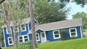 A two-story house with a blue exterior and a grey roof. -     Creekside Private Room & Bathroom  Fishing  Peaceful Retreat (Clute)