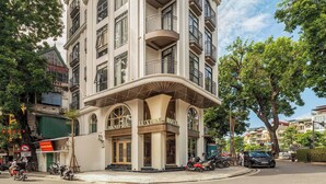 A multi-story building with a grand entrance, large windows, and balconies. - Grand Sol Luxury Boutique Hotel (Hanoi)