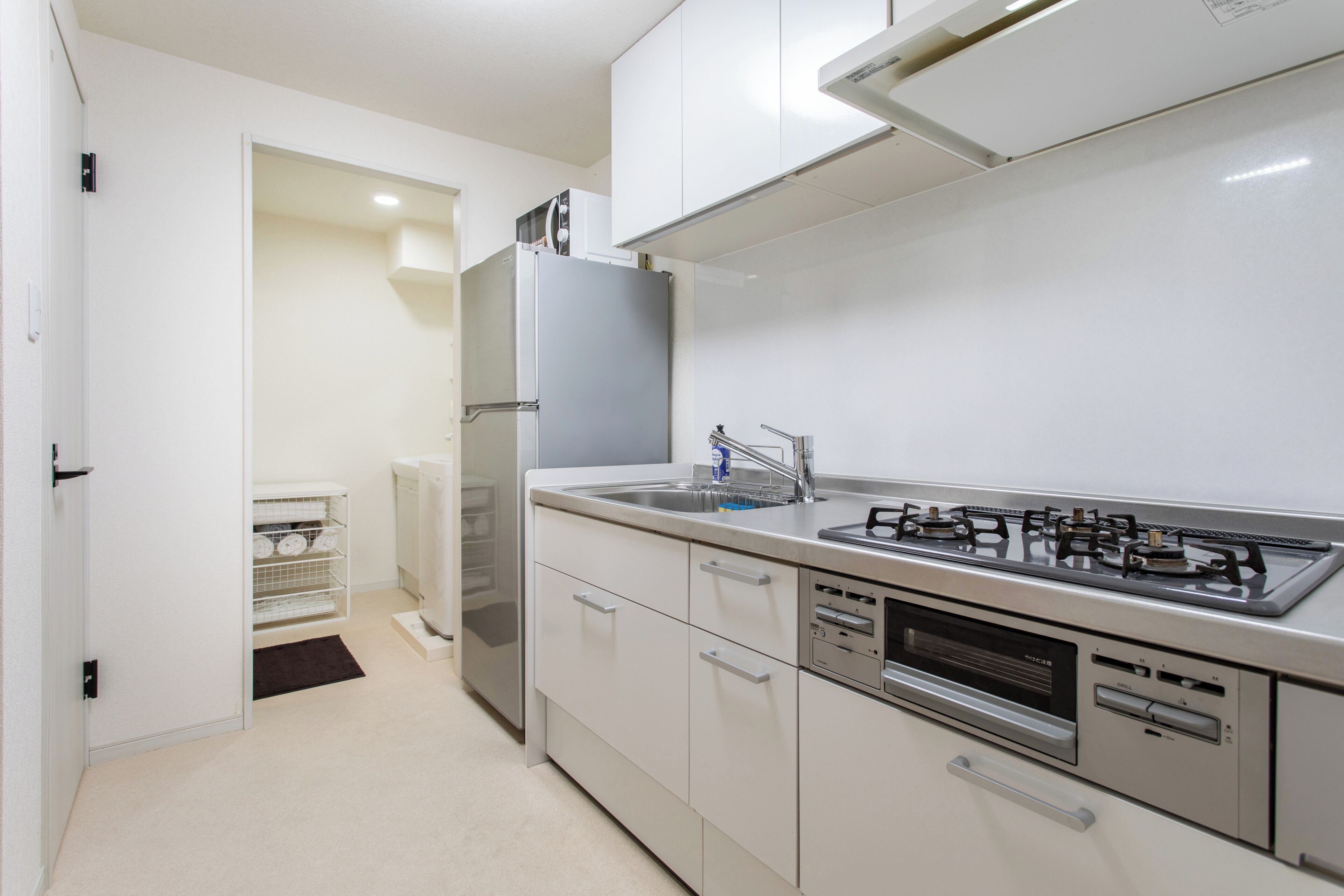 A modern kitchen with a stainless steel range, a built-in oven, and a dishwasher.