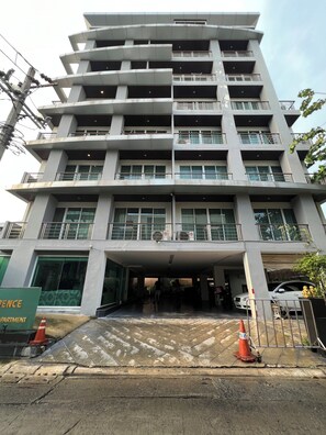 A multi-story building with a central entrance, balconies, and a parking area. - P Residence Thonglor  (Bangkok)