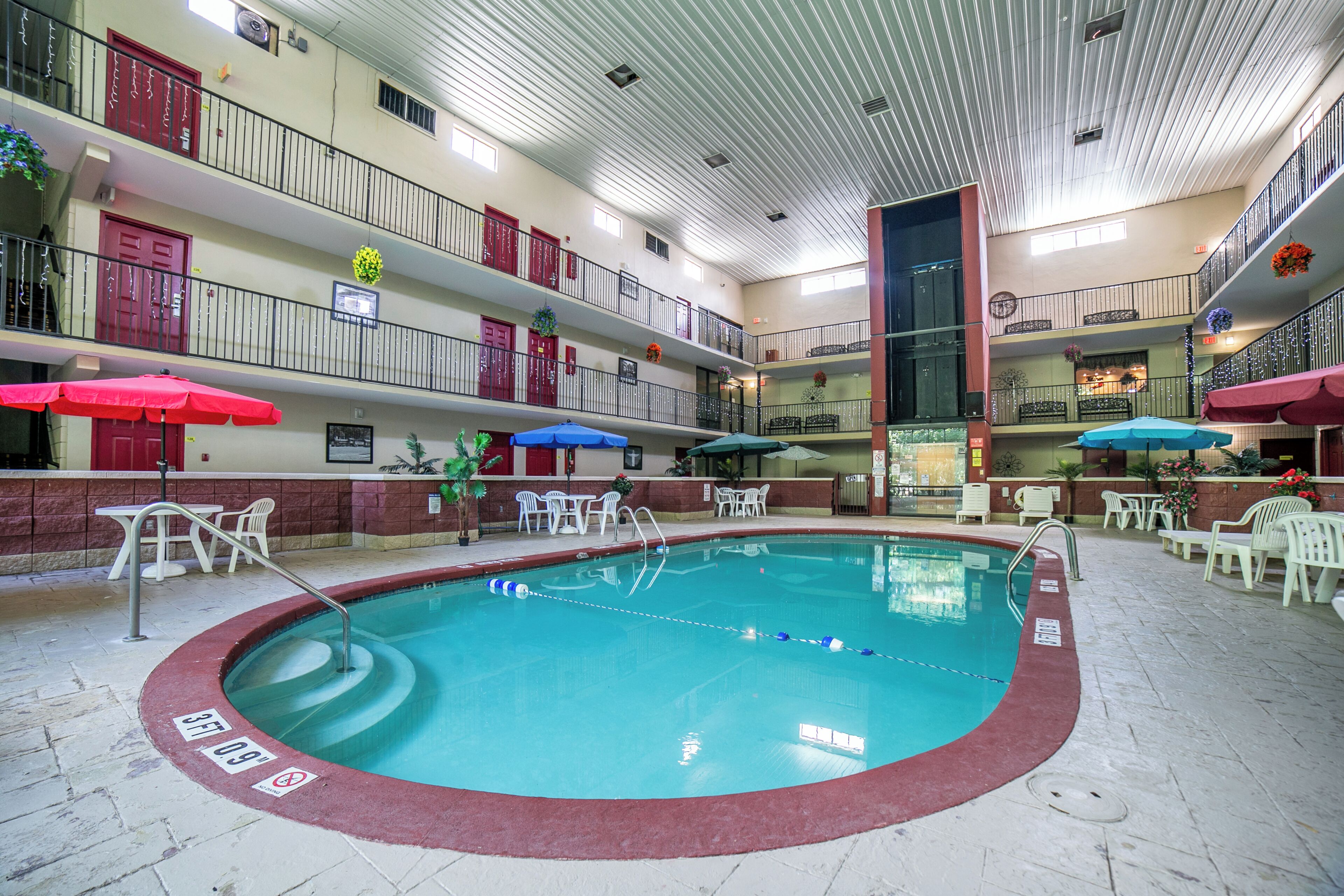 Indoor pool, open 9:00 AM to 10:00 PM, pool umbrellas