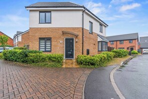 A two-story residential building with a brick facade, a black front door, and a number '18' on the wall. - #16 Stunning 3 Bed home|near Core Theatre|Sleep 7 (West Midlands)