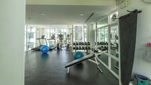 A gym with treadmills, exercise balls, and weight racks. - The Regent Kamala Condominium by PSR (Tambon Kamala)