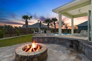 A backyard with a fire pit, outdoor seating, and a swimming pool. - Windmark Coastal Paradise 5BR/5BA, private Pool, sleeps 18, pet friendly, 2 golf carts (Port St. Joe)