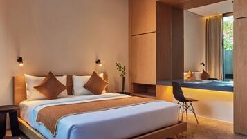 A modern bedroom with a large bed, bedside tables, a desk, and a mirror.