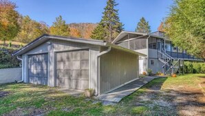 A two-story house with a garage and a covered porch. - Rhododendron Retreat— Dog-Friendly, Sauna, Mountain Views, Appalachian Trail (Roan Mountain)