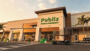 A Publix Food & Pharmacy store with a large sign, a parking lot, and a shopping cart outside. - 3BR Luxury North Retreat with Pool and Gym (Naples)