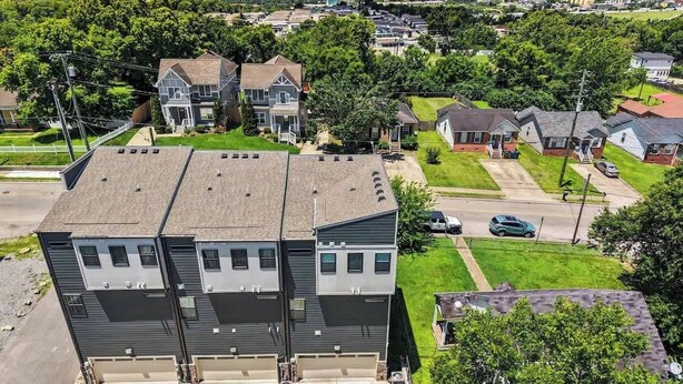 A multi-story residential building with a garage, a driveway, and a lawn. - Music-Themed Nashville Home | 4BR, 4 Baths & Bunk (Nashville)
