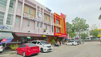A hotel with a sign reading 'The Arden's Hotel' and a restaurant named 'Soon Shing' on the ground floor.