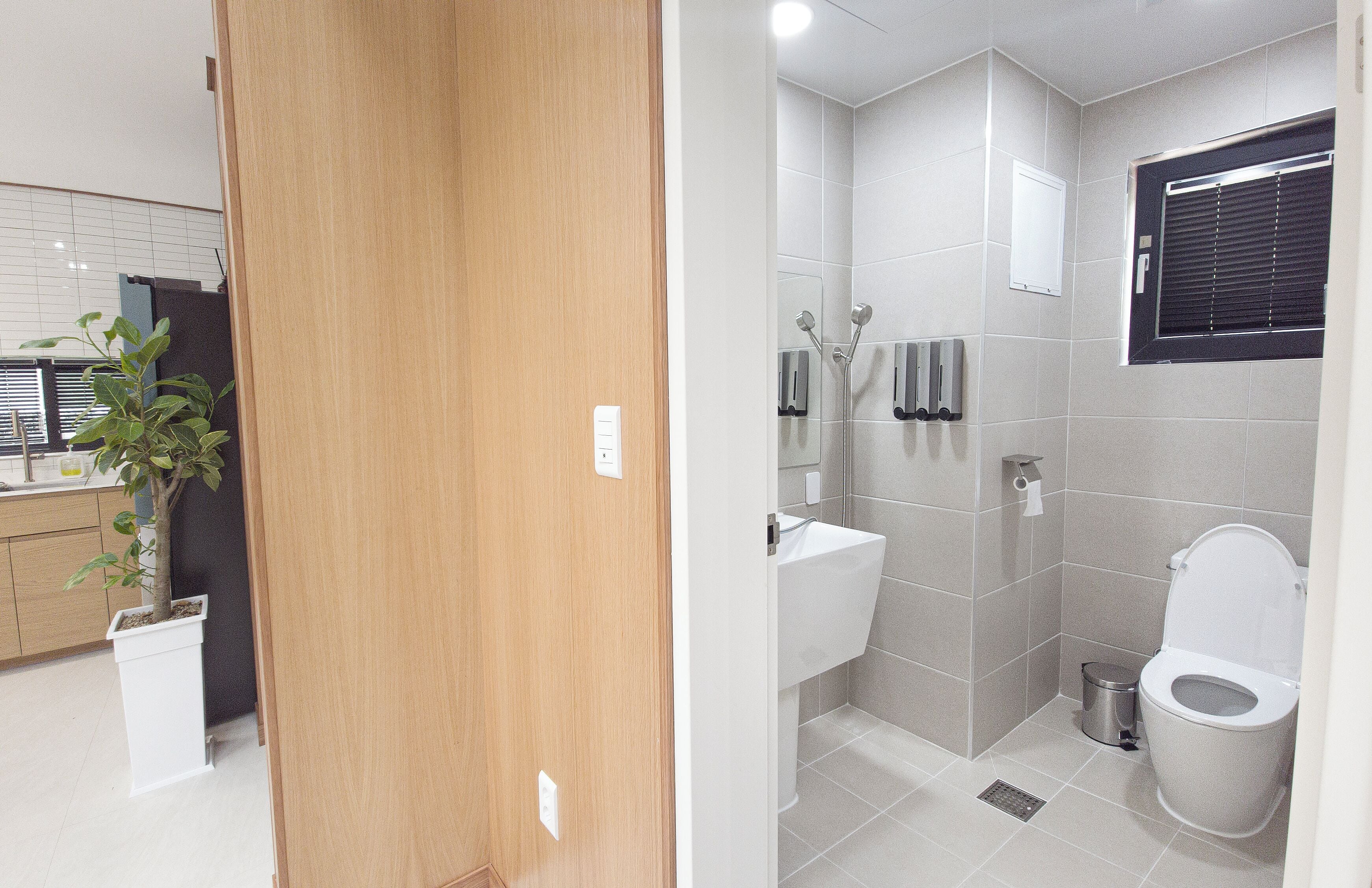 A bathroom with a shower, toilet, and sink.