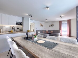 A modern living space with a dining area, kitchen, and seating area. - Vacation home LaLuMa by Interhome (Pula)