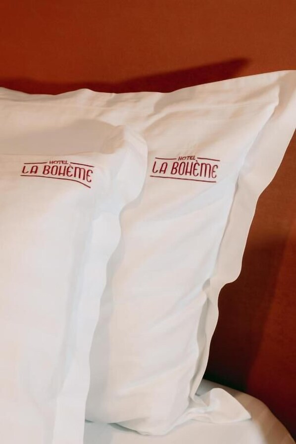 A pillow with 'HOTEL LA BOWHEM' printed on it.
