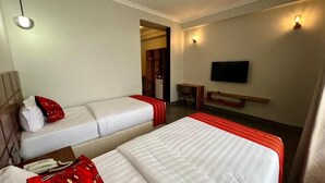 A hotel room with two beds, a desk, a television, and a wardrobe. - Iwandaa Boutique Hotel (Arusha)