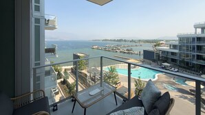 Een balkon met uitzicht op een zwembad en een jachthaven.