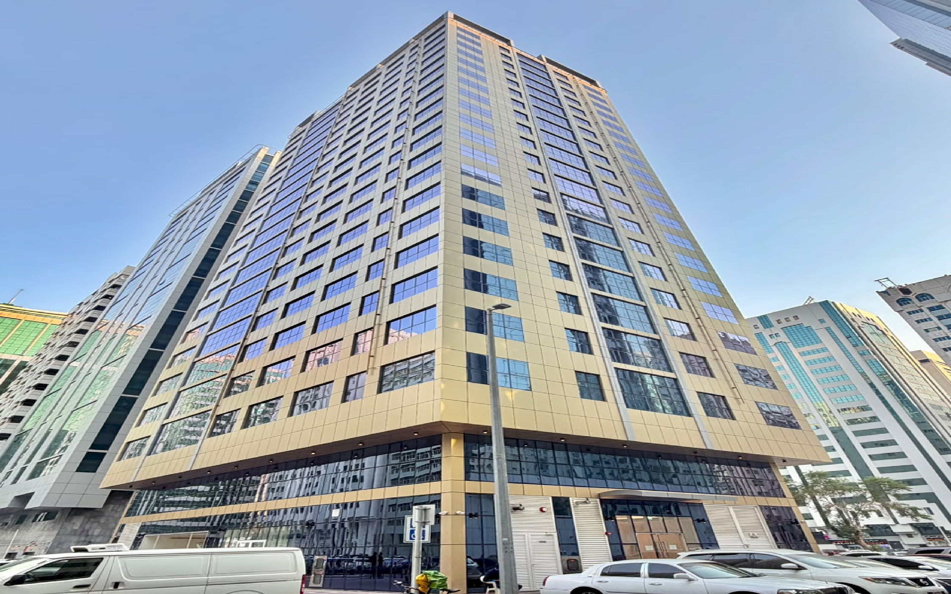 A high-rise building with multiple floors, large windows, and a modern architectural design.