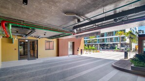 An indoor area with a tiled floor, a door leading to a room, and a view of a building with a 'NO ENTRY' sign. - Seashore Residences, Three-Bedroom 3B Deluxe (Thalang)