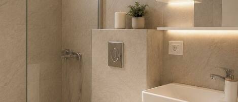 A modern bathroom with a glass-enclosed shower, a toilet, and a vanity with a mirror.