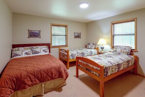 A bedroom with two single beds, a nightstand with a lamp, and two wall-mounted picture frames. - Great for Families! Wolf pen Gap ATV Base on Creek (Mena)