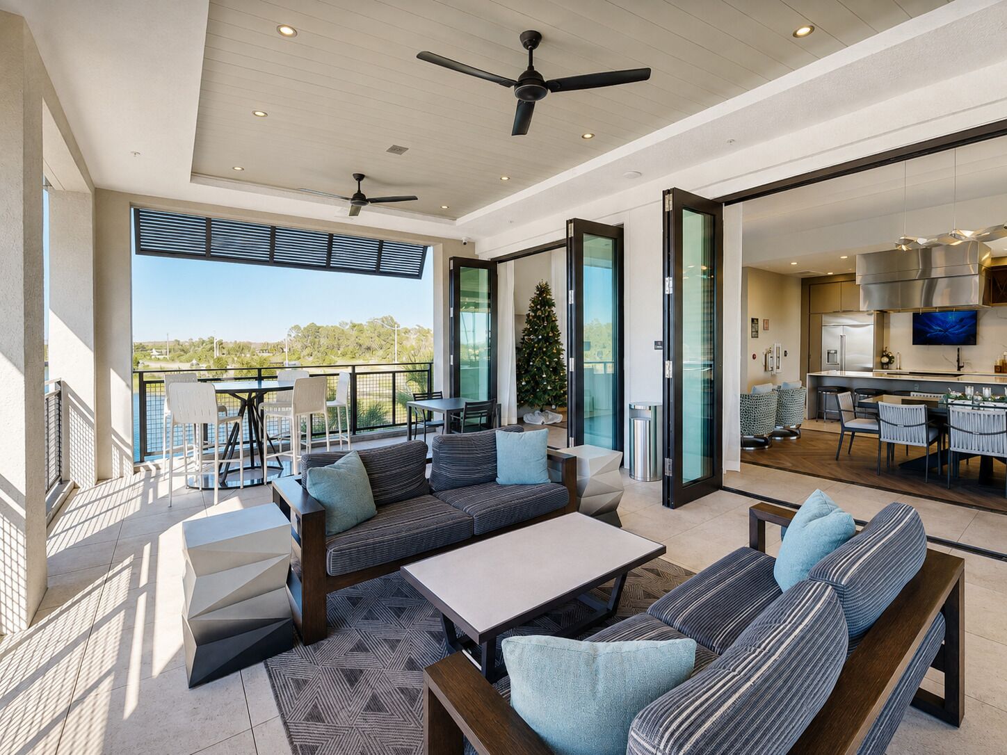A spacious living area with a balcony, a dining area, and a kitchen.