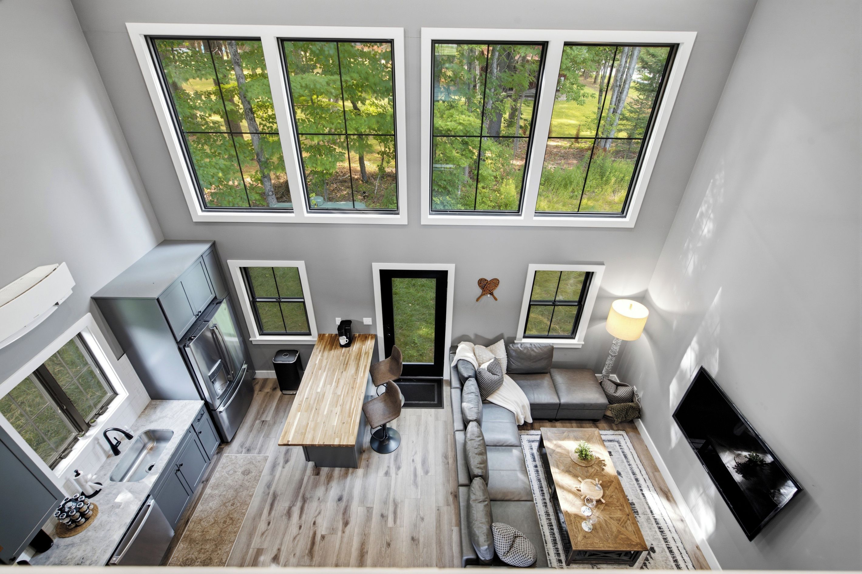 A modern kitchen with a built-in oven and a dining area with a wooden table and chairs.