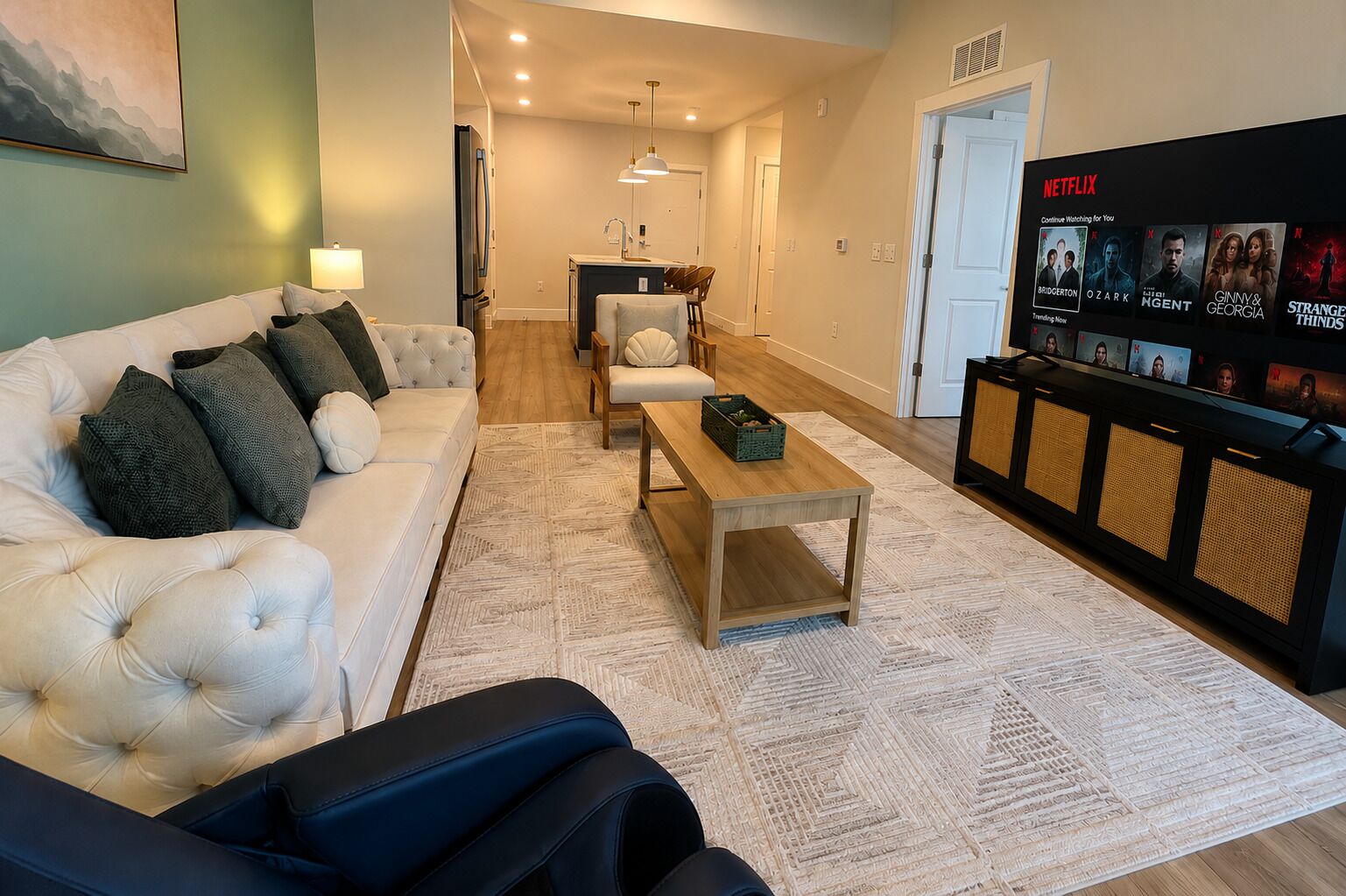 A modern living room with a sofa, coffee table, and a TV displaying Netflix content.