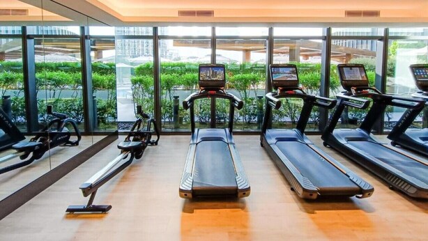 A gym with treadmills, stationary bikes, and a rowing machine. - The Address Dubai Opera T1 - Skyline Luxe 1BR | Burj Khalifa & Dubai Mall (Downtown)