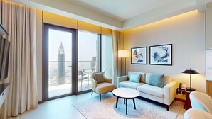 A modern hotel room with a sofa, armchair, and a small table. - The Address Dubai Opera T1 - Skyline Luxe 1BR | Burj Khalifa & Dubai Mall (Downtown)