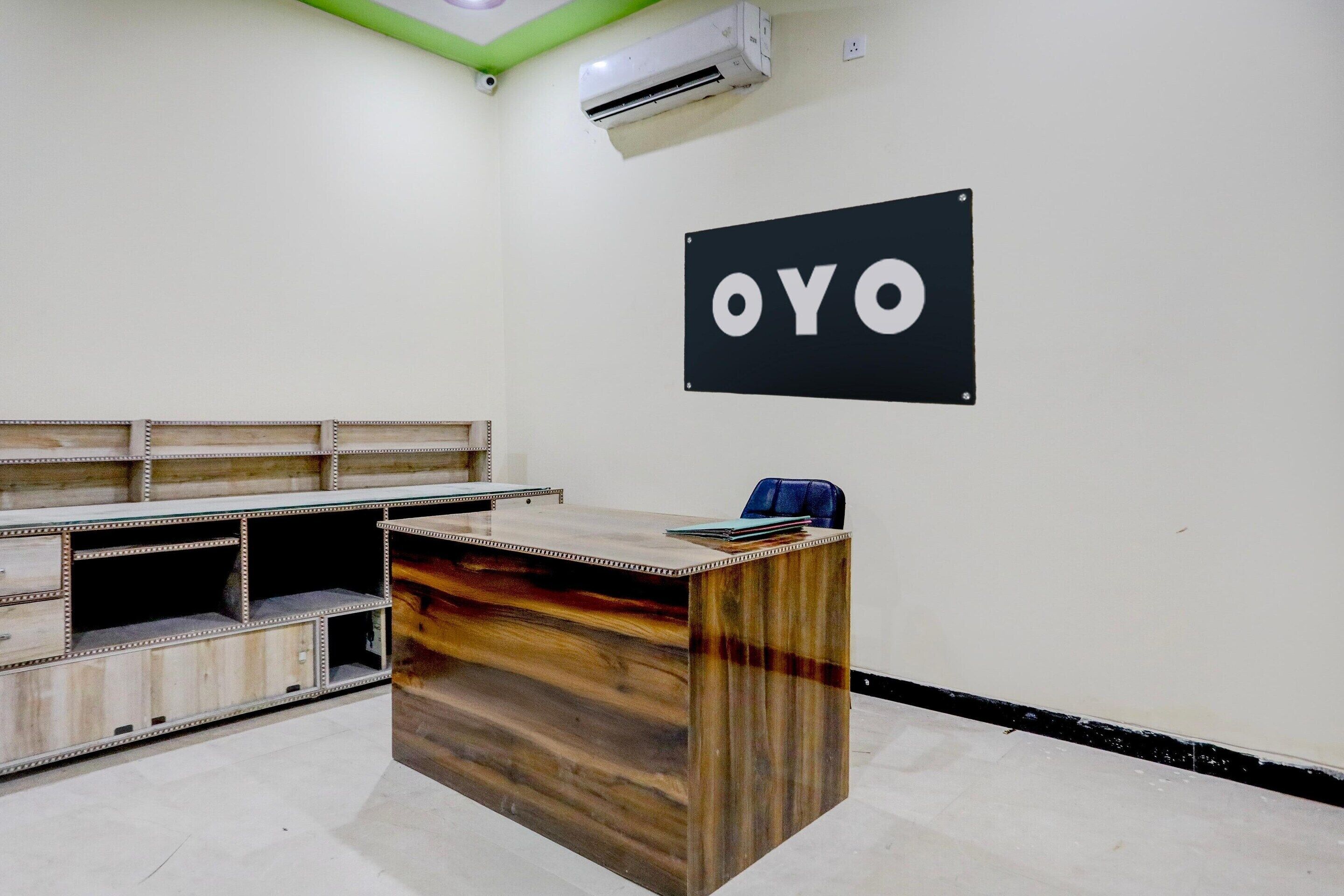 A reception desk with a sign that reads 'OYO' on the wall.
